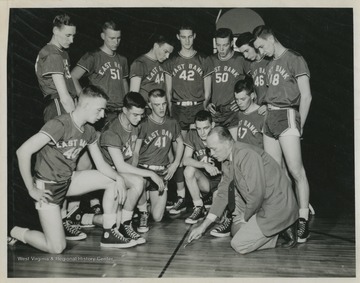 Jerry West, No. 42, is pictured with his high school basketball team and Coach Roy Williams.West was the team's starting small forward. He was named All-State from 1953–56, then All-American in 1956 when he was West Virginia Player of the Year, becoming the state's first high-school player to score more than 900 points in a season.West also led his team to victory at the West Virginia State High School Basketball Championship in 1956, a first for the team. 