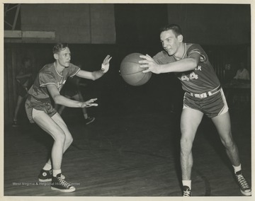 Leonord Greer, left, and Robert Buckley, right, are pictured during a drill at practice. The boys were teammates of Jerry West during his high school basketball career.The 1956 basketball team secured the first ever state championship title for the high school.