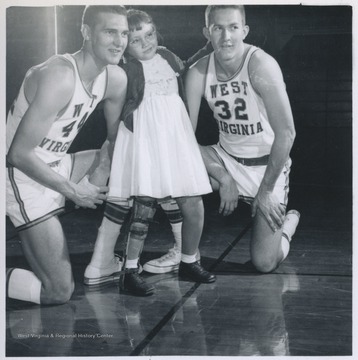 West, left, and Akers, right, pose with an unidentified young girl. 