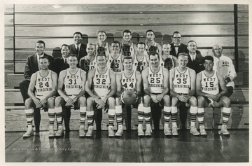 In the front row is Jim Warren, Paul Miller, Willie Akers, Jerry West, Joe Posch, Jim Ritchie, and Lee Patrone.In the middle row is Coach Fred Schaus, Asst. George King, Ed Bode, Nick Serdich, Kenny Ward, Butch Goode, freshman coach Quentin Barnette, and trainer Whitey Gwynne.In the back row is manager Tony Minard, Dick DuBois, Nick Visnic, Paul Popovich, and equipment custodian Carl Roberts. 
