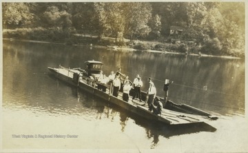 A boat transporting unidentified people crosses the Cheat River.