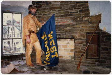 West Virginia University's 1986-1987 mascot poses in a building in the Old Mountaineer Field before the demolition in 1987. 