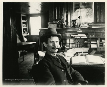 This image is part of the Thompson Family of Canaan Valley Collection. The Thompson family played a large role in the timber industry of Tucker County during the 1800s, and later prospered in the region as farmers, business owners, and prominent members of the Canaan Valley community.  Albert Thompson of Philadelphia bought the J.L. Rumbarger Lumber Company of Tucker County in the late nineteenth century.  He later built his business, the Thompson Lumber Company, which later became the Blackwater Boom and Lumber Company.A caption on the back of the image reads: "Chas Blake [Charles], Phila. office, A. Thompson's desk."