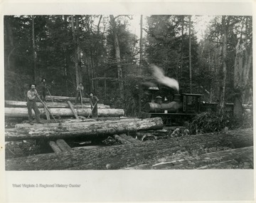 This image is part of the Thompson Family of Canaan Valley Collection. The Thompson family played a large role in the timber industry of Tucker County during the 1800s, and later prospered in the region as farmers, business owners, and prominent members of the Canaan Valley community.Men are seen loading spruce logs for transportation to the mill. The engine seen was the first shay locomotive, number 142, on Thompson job. 