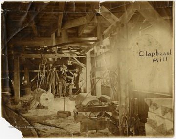 This image is part of the Thompson Family of Canaan Valley Collection. The Thompson family played a large role in the timber industry of Tucker County during the 1800s, and later prospered in the region as farmers, business owners, and prominent members of the Canaan Valley community.Four men are seen here standing inside Clapboard Mill.