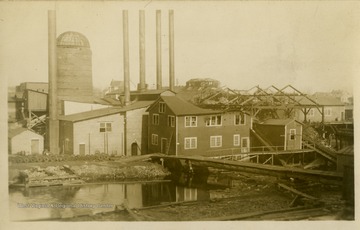 This image is part of the Thompson Family of Canaan Valley Collection. The Thompson family played a large role in the timber industry of Tucker County during the 1800s, and later prospered in the region as farmers, business owners, and prominent members of the Canaan Valley community.A partially burned mill including the boiler and burner are damaged.
