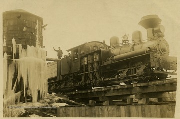 The Shay Locomotive passes an ice covered water tower in an unidentified location.This image is part of the Thompson Family of Canaan Valley Collection. The Thompson family played a large role in the timber industry of Tucker County during the 1800s, and later prospered in the region as farmers, business owners, and prominent members of the Canaan Valley community.