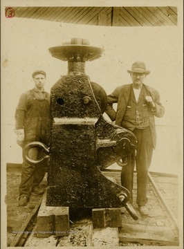 This image is part of the Thompson Family of Canaan Valley Collection. The Thompson family played a large role in the timber industry of Tucker County in the 1800s, and later prospered in the region as farmers, business owners, and prominent members of the Canaan Valley community.The two men pose next to the "Headworks" invented by Fred Viering (right) of Babcock Lumber. Also shown is skidded Lumber from Blackwater Canyon and Red Run Canyon, W. Va.