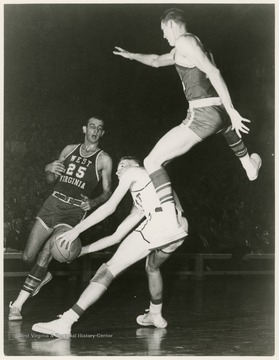 West jumps to block Pitt's Dick Falenski as he attempts to shoot.  The Mountaineers won this game at Pittsburgh, 76-66.