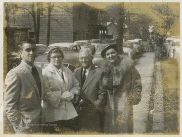 The group poses for a photograph before being welcomed into the game, where Jerry West led the East Bank High School basketball team to its first ever West Virginia state championship title.Pictured from left to right is son of Ethel and Ivan Rose, Ethel Rose, Ivan Rose, and Wilhelmina Williams, wife to East Bank High School basketball coach Roy Williams. 