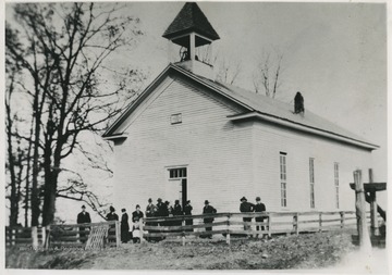 A group of church m embers are gathered outside of the building which was built in 1880. The organization was established in 1847.