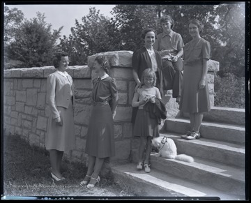 Participants in the fashion show gather along the stairs. Subjects unidentified. 