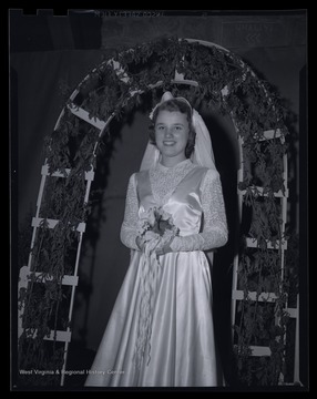 An unidentified woman poses on the stage of the fashion show. 
