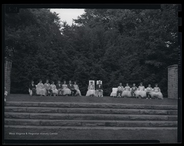 The royal court is pictured on a lawn stage. Subjects unidentified. 