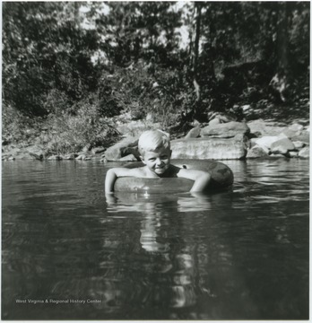 A young, unidentified boy floats in a tube in what is also known as Greenbrier Springs. The springs are located along the Greenbrier River. 
