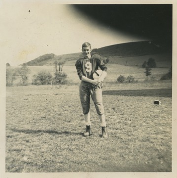 Sisler poses in his football uniform. 