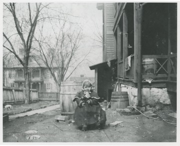 Side of the Flanagan home looking towards Summers Street.  Small child sits near a side porch.