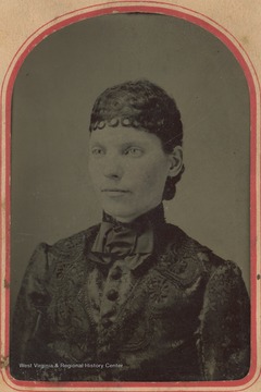 Female member of the Lightner family with elaborately curled hair, possibly a wig.