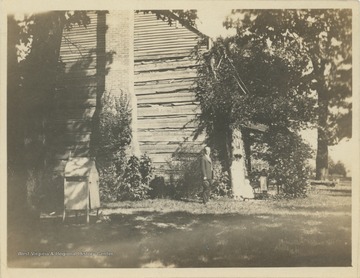 "Oldest house in Wood County. Situated in City Park, Parkersburg, W. Va."  Subjects identified as John, Ethel, Vernah, Merrie, and Rosalie Stewart.