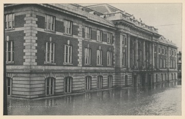 Photo postcard of a Baltimore and Ohio building during a 1913 flood in Wheeling, W. Va. Postcard is part of a souvenir book of 1913 flood images.