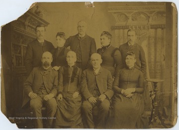 In the front row, from left to right, is Robert Menfee's son-in-law; Elizabeth Poulson; Robert Menfee; and Mrs. William Menfee.In the back row, from left to right, is Robert Menfee's youngest son; Robert Menfee's daughter; William Menfee; Mrs. Clark Menfee; and Clark Menfee, Robert Menfee's son. 
