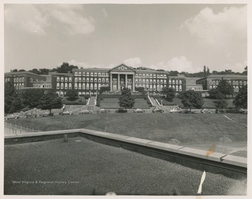 View of Woman's Hall, now Stalnaker Hall, from the roof of a neighboring building.  Several cars are visible on Maiden Lane in front of the building.