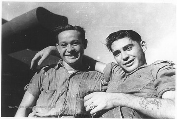 Two sailors pose together for a photo. The man on the right is likely named Al. Photos are from an album belonging to a member of the U.S.S. West Virginia.  William Wright, Radio Technician 2C, was on the ship from 1944-45 and saw action at Leyte Gulf, Iwo Jima, and Okinawa.  