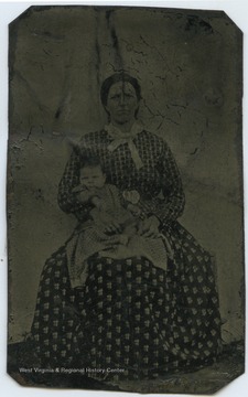 Mrs. Samuel F. Harsh (b. 1839-d. 1922) is pictured holding an unidentified child. 
