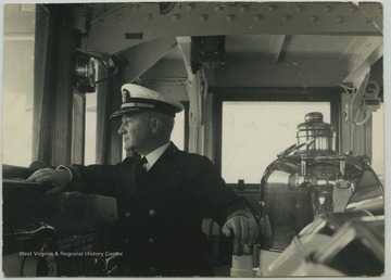 Captain William Furlong peers out at the navigation bridge during a U.S.S. West Virginia voyage. 
