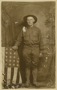 Zinn is pictured a soldier's uniform beside an American flag. Zinn is from North Central West Virginia, which includes Monongalia, Taylor and Barbour counties. 