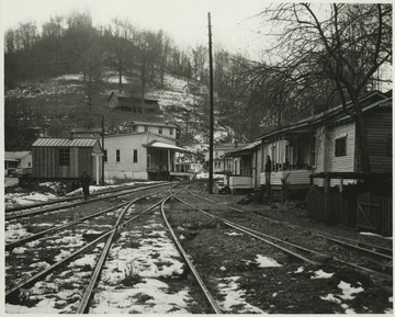 A coal miner walks along the snow covered tracks which run through a miner village in Cameo, Boone County, W. Va.