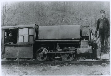 Engineer C. V. Berry, left, and brakeman Walter Bennett, right, are pictured with the coal company's railway engine. 