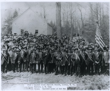The "Improved Order of Red Men" are pictured in the forefront of the photograph wearing sashes. The pastor of this church was J. W. Legg.