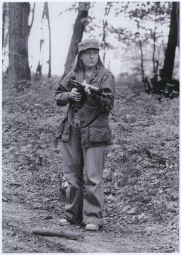 Abrams is pictured holding a gun during the War Games on Caddell Mountain.