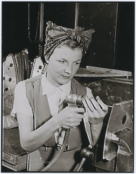 Fern Evan's husband, GM3e Woodrow W. Evans was killed aboard the U.S.S. West Virginia during the Japanese attack on Pearl Harbor on December 7, 1941, leaving Fern to support herself and their 20 month old son.  Subsequently, Mrs. Evans was employed at a West Coast aircraft plant.  She's shown here working on a radio bracket for a bomber.