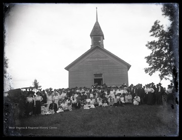 Members of the church and clergy pose outside of the church building which is located in Preston County, W. Va.