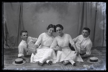 Two men and two women pose for a portrait.