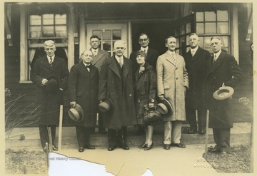 John Roscoe Turner, center, stands with unidentified associates outside of the old music building on this day of his inauguration. 