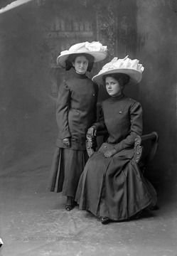 Grace, left, is daughter of photographer William R. Loar. She was born February 5, 1892 and died April 28, 1937.  The two women are wearing hats and dresses, which appear to be some sort of uniform.