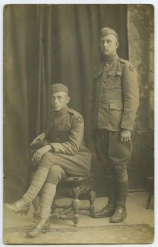 Sparks and an associate are dressed in military uniforms. 