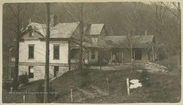 "The best view of "Holly Hall," showing the back pourch [sic] where we all congregate in the evenings after supper to smoke, sing, and talk."This photograph is found in a scrapbook documenting the survey for the Baltimore and Ohio Railroad in West Virginia and surrounding states. 