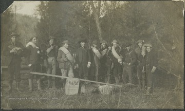 A group of men pose with supplies before their journey to Camp "High Life," where they slept in the open for several nights.This photograph is found in a scrapbook documenting the survey for the B. & O. Railroad in West Virginia and surrounding states. 