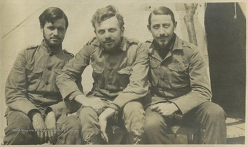 Men identified as "Rat" (left), "Lew" (center), and "Doc" (right) pose together for a photo.This photograph is found in a scrapbook documenting the survey for the Baltimore and Ohio Railroad in West Virginia and surrounding states. 
