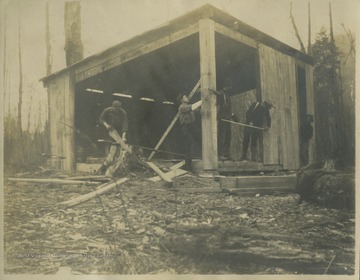Surveyors build dining hall for their campsite.This photograph is found in a scrapbook documenting the survey for the Baltimore and Ohio Railroad in West Virginia and surrounding states. 