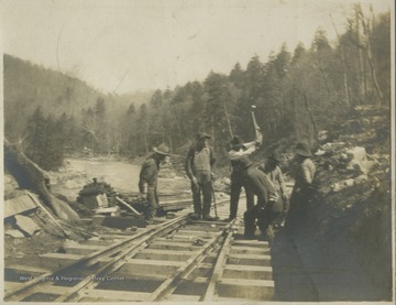 Surveyors construct a lumber road.This photograph is found in a scrapbook documenting the survey for the Baltimore and Ohio Railroad in West Virginia and surrounding states. 