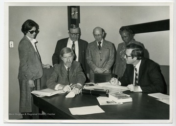 Standing left to right:Martha Trocin, William L. Young, Charles. Edward. Campbell Beall, Victorine Louistall-MonroeSeated left to right:Frederic Jay. Glazer and John Davison (Jay) Rockefeller, IVTrocin, Young, Beall, and Louistall-Monroe were all members (Commissioners) of the West Virginia Library Commission.