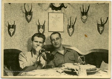 Melvin H. Kimble and unidentified man at a bar in Germany before the Battle of the Bulge.