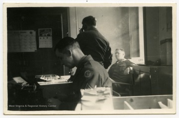 Melvin H. Kimble, at center, in his office in Germany.