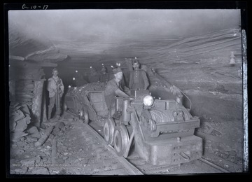 Men with loaded coal cars being hauled out of mine