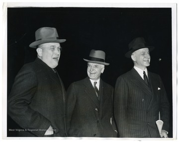 Assistant Secretary of War Louis Johnson, Secretary of State Cordell Hull, and Undersecretary of State Sumner Welles (left to right) wait at a Washington D. C. station for President Roosevelt to discuss the Nazi invasion of Denmark and Norway.
